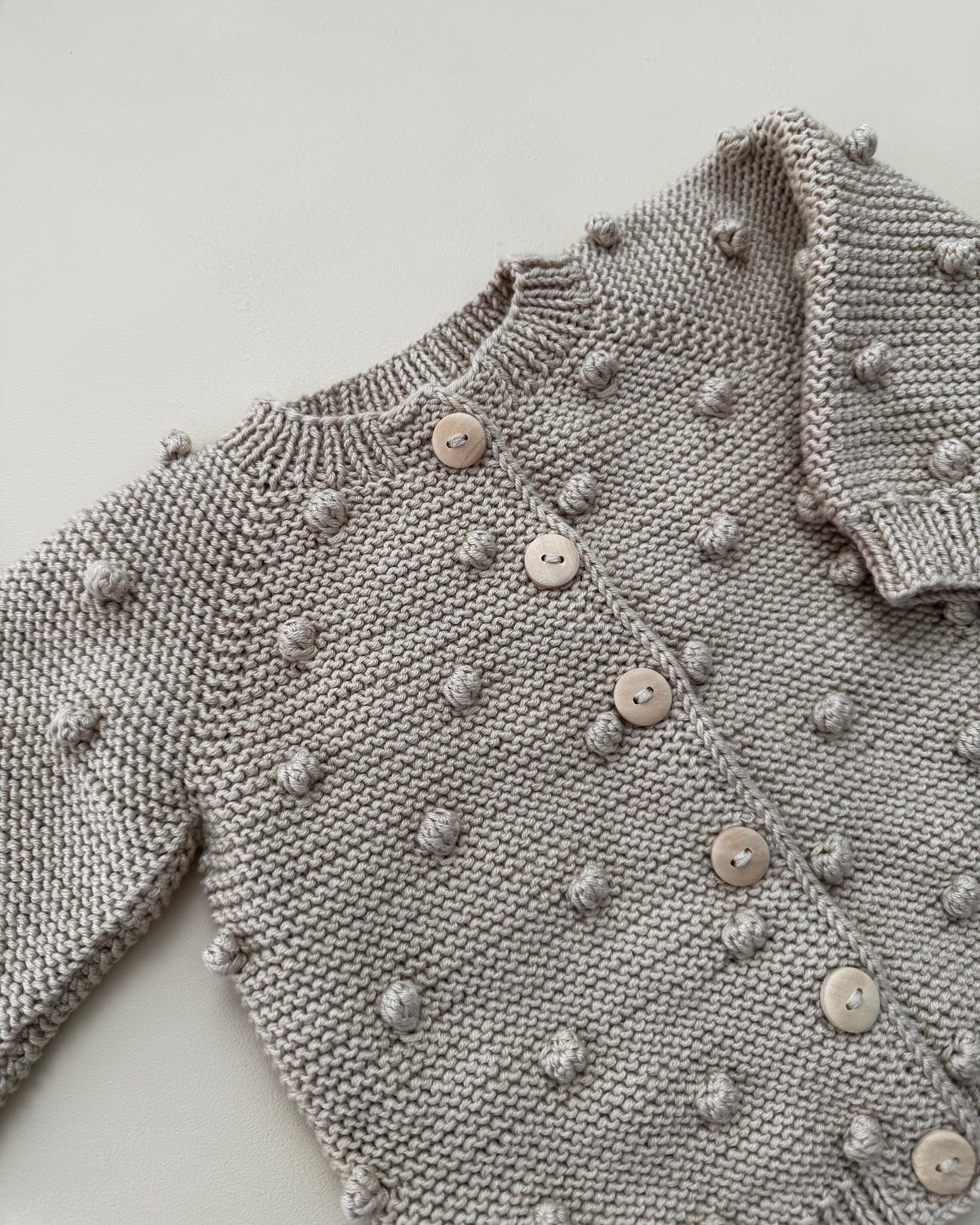 Organic cotton vest with pom poms